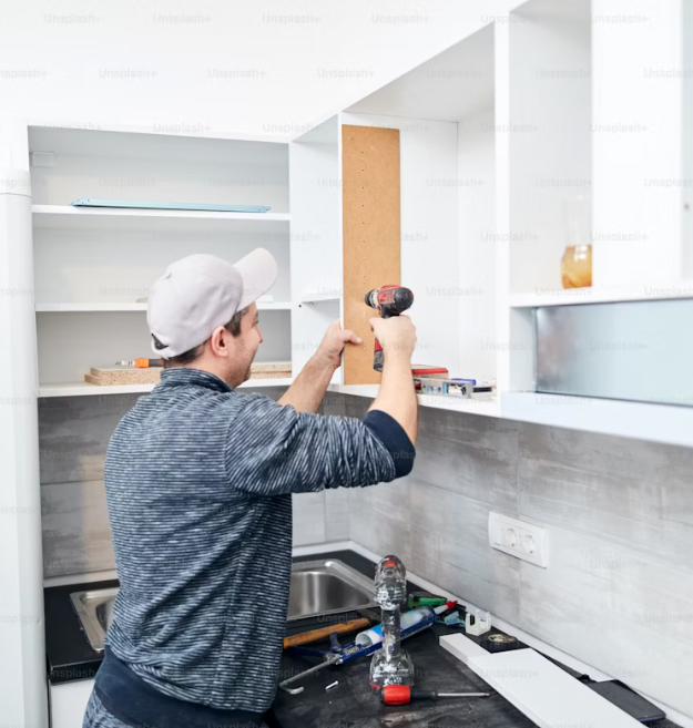 Man is installing cabinet